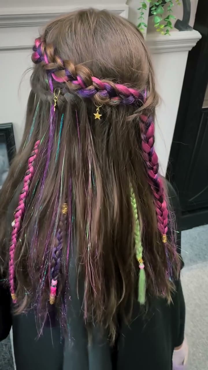 A Girls' Club guest's hair styled with colourful tinsel braids at Beaux Cheveux.