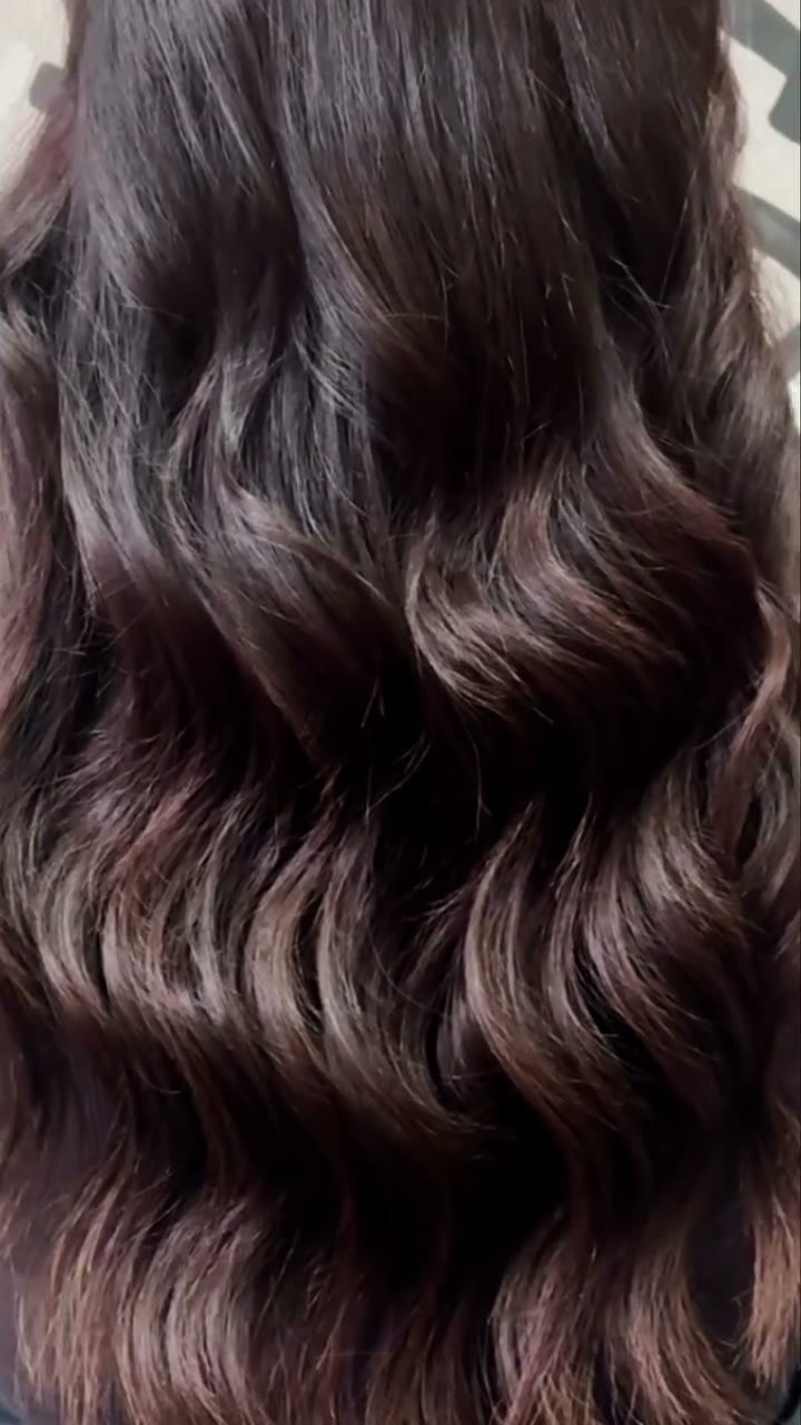Glossy, deep-brunette waves — a full head of luxury 100% Remy extensions fitted at Beaux Cheveux.